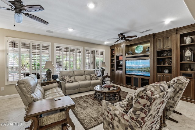living room featuring ceiling fan, plenty of natural light, and built in features