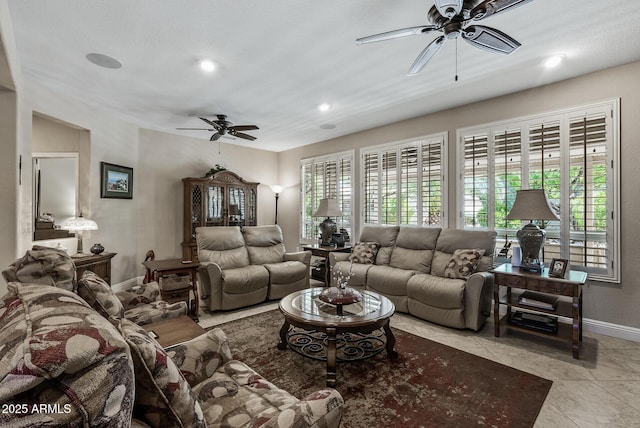 living room featuring baseboards, ceiling fan, recessed lighting, and tile patterned flooring