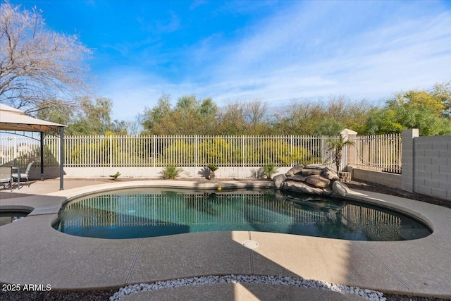 view of swimming pool with a patio area, a fenced backyard, a fenced in pool, and a gazebo