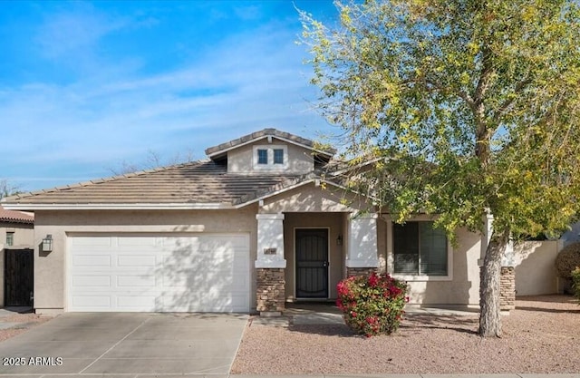 view of front of property with driveway, an attached garage, a tile roof, and stucco siding