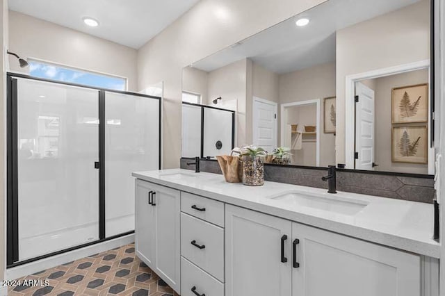 bathroom featuring vanity and a shower with shower door