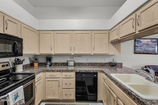 kitchen featuring black appliances and light brown cabinets