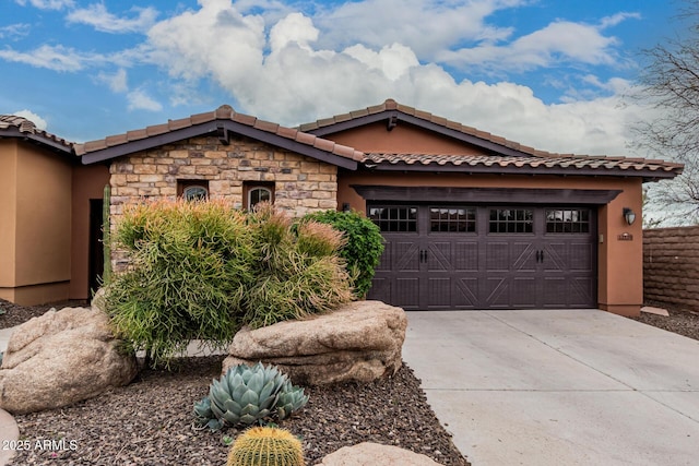 view of front facade featuring driveway, a garage, stone siding, fence, and stucco siding