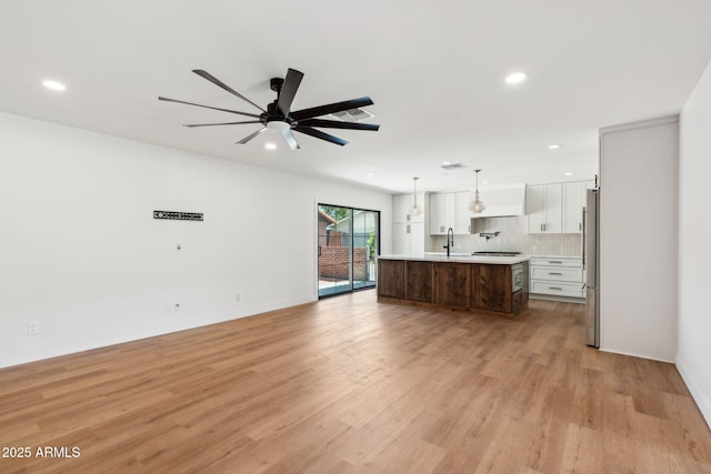 20 W Pasadena Ave, Phoenix, AZ 85013 - unfurnished living room featuring recessed lighting, light wood-style flooring, a sink, ceiling fan, and baseboards