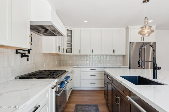 20 W Pasadena Ave, Phoenix, AZ 85013 - kitchen featuring custom exhaust hood, appliances with stainless steel finishes, a sink, white cabinetry, and hanging light fixtures