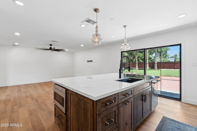 20 W Pasadena Ave, Phoenix, AZ 85013 - kitchen with a sink, appliances with stainless steel finishes, recessed lighting, light wood finished floors, and hanging light fixtures