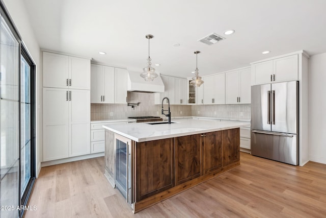 20 W Pasadena Ave, Phoenix, AZ 85013 - kitchen featuring high quality fridge, a sink, light wood-style flooring, beverage cooler, and tasteful backsplash