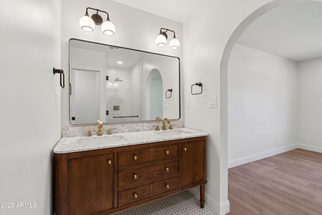 20 W Pasadena Ave, Phoenix, AZ 85013 - bathroom with double vanity, a stall shower, and baseboards