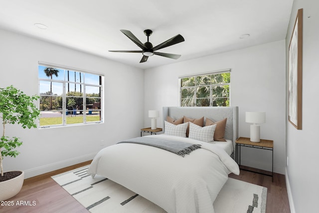 20 W Pasadena Ave, Phoenix, AZ 85013 - bedroom with multiple windows, baseboards, wood finished floors, and ceiling fan