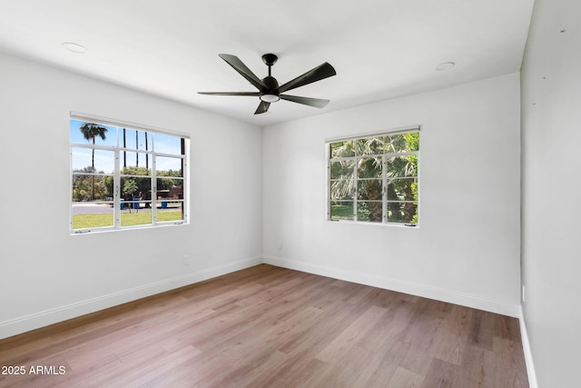 20 W Pasadena Ave, Phoenix, AZ 85013 - unfurnished room with wood finished floors, healthy amount of natural light, a ceiling fan, and baseboards
