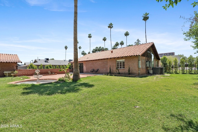 20 W Pasadena Ave, Phoenix, AZ 85013 - rear view of property featuring a tile roof, central AC, a patio, and brick siding