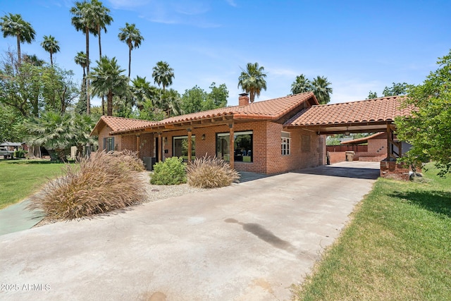 20 W Pasadena Ave, Phoenix, AZ 85013 - view of front of home featuring a tiled roof, a chimney, concrete driveway, a front yard, and brick siding