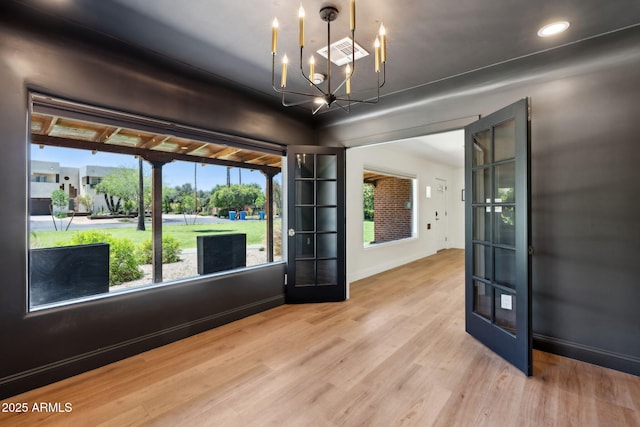 20 W Pasadena Ave, Phoenix, AZ 85013 - unfurnished room with a chandelier, wood finished floors, baseboards, french doors, and recessed lighting