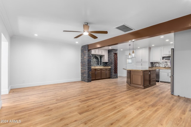 unfurnished living room featuring crown molding, ceiling fan, and light hardwood / wood-style floors