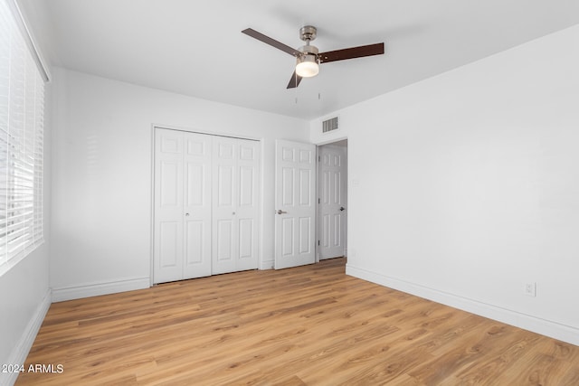 unfurnished bedroom with ceiling fan and light hardwood / wood-style floors