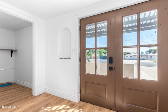 entryway with french doors and light hardwood / wood-style floors