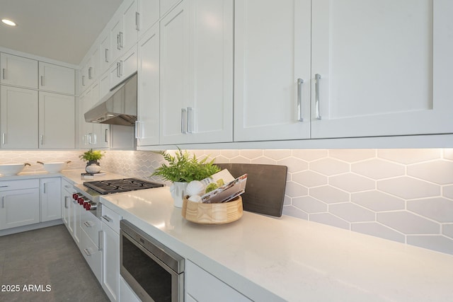 12326 E Black Rock Rd, Scottsdale, AZ 85255 - kitchen featuring backsplash, light countertops, stainless steel appliances, and under cabinet range hood