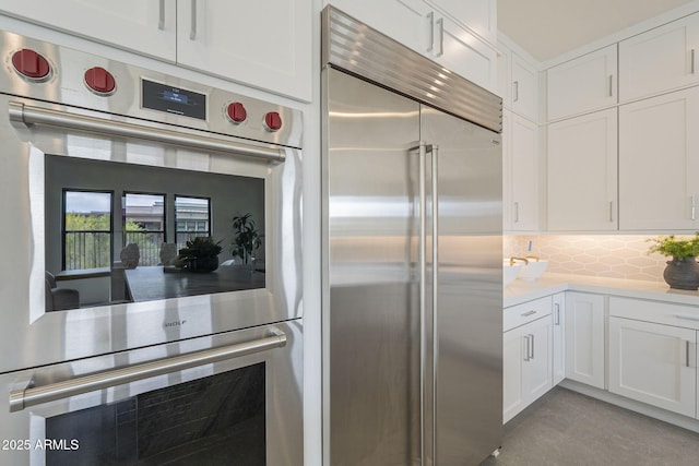 12326 E Black Rock Rd, Scottsdale, AZ 85255 - kitchen with stainless steel appliances, white cabinetry, light countertops, and decorative backsplash