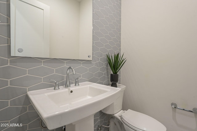 12326 E Black Rock Rd, Scottsdale, AZ 85255 - bathroom with tasteful backsplash, tile walls, a sink, and toilet