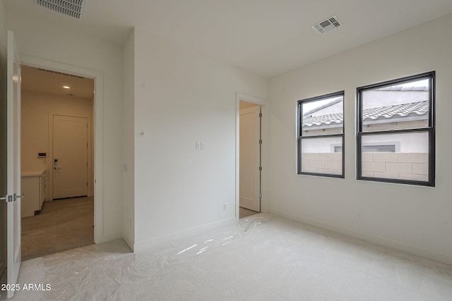 12326 E Black Rock Rd, Scottsdale, AZ 85255 - spare room featuring visible vents, light colored carpet, and baseboards
