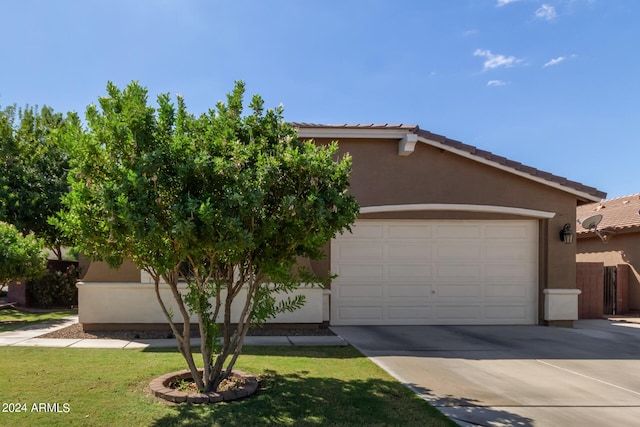 view of front of house with a front lawn, concrete driveway, and stucco siding