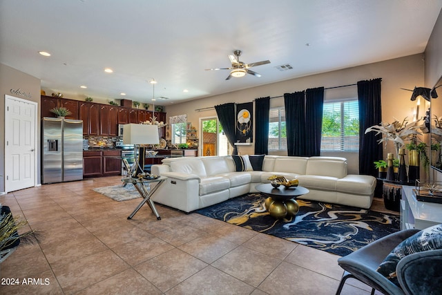 living room featuring ceiling fan and light tile patterned floors