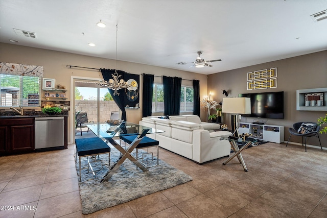 living room with ceiling fan with notable chandelier, sink, and light tile patterned floors