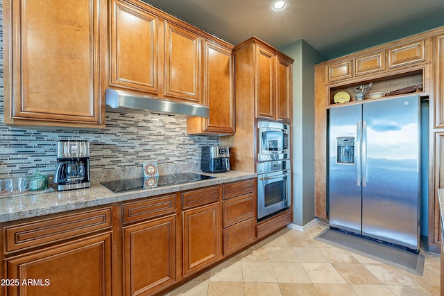 16336 E Ridgeline Dr, Fountain Hills, AZ 85268 - kitchen featuring stainless steel appliances, under cabinet range hood, brown cabinetry, and tasteful backsplash