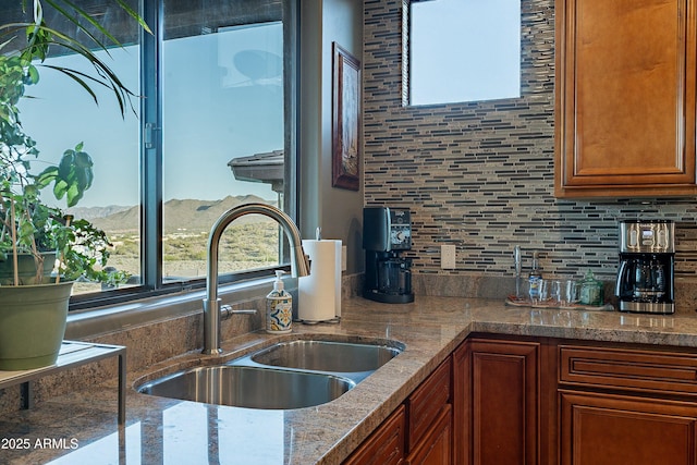 16336 E Ridgeline Dr, Fountain Hills, AZ 85268 - kitchen featuring a sink, a mountain view, decorative backsplash, stone countertops, and brown cabinets