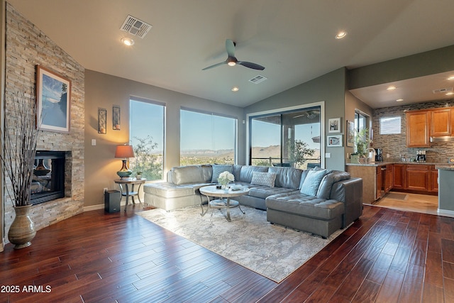 16336 E Ridgeline Dr, Fountain Hills, AZ 85268 - living room with a stone fireplace, visible vents, dark wood-style flooring, and a healthy amount of sunlight