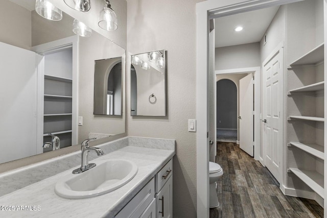 4343 E Soliere Ave Unit 2070, Flagstaff, AZ 86004 - bathroom with wood finished floors, toilet, and vanity