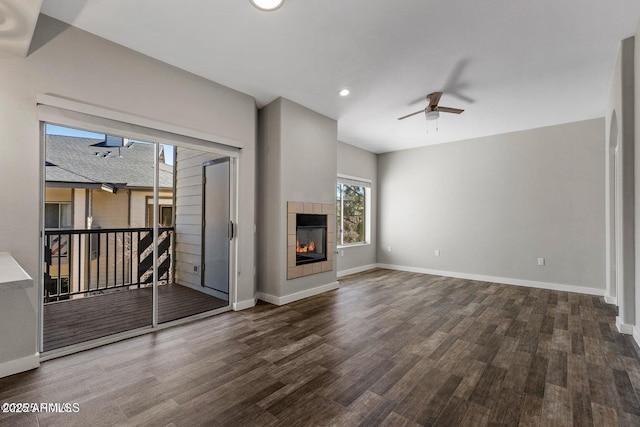 4343 E Soliere Ave Unit 2070, Flagstaff, AZ 86004 - unfurnished living room with baseboards, wood finished floors, recessed lighting, a tiled fireplace, and a ceiling fan