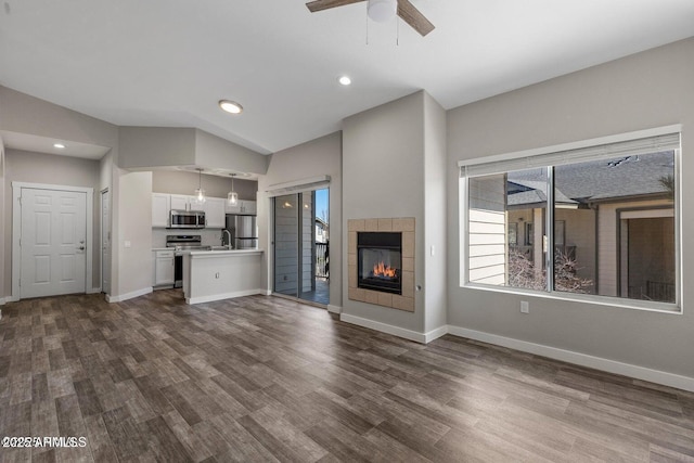 4343 E Soliere Ave Unit 2070, Flagstaff, AZ 86004 - unfurnished living room featuring dark wood finished floors, baseboards, lofted ceiling, and a ceiling fan