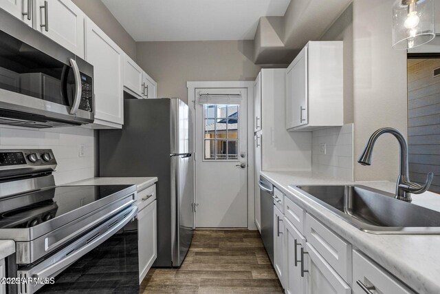 4343 E Soliere Ave Unit 2070, Flagstaff, AZ 86004 - kitchen featuring light countertops, white cabinets, appliances with stainless steel finishes, a sink, and dark wood-style floors