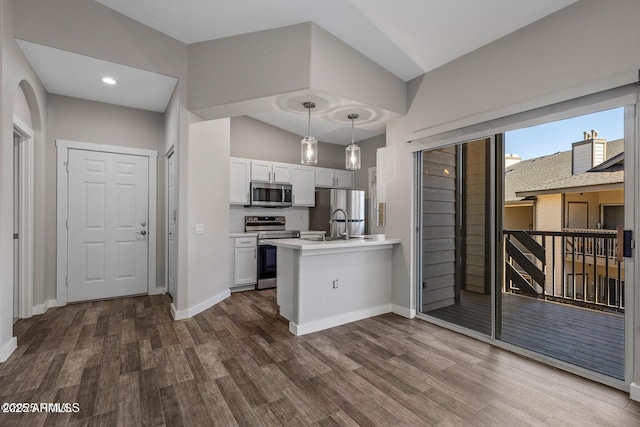 4343 E Soliere Ave Unit 2070, Flagstaff, AZ 86004 - kitchen with white cabinetry, dark wood-style flooring, stainless steel appliances, hanging light fixtures, and a peninsula