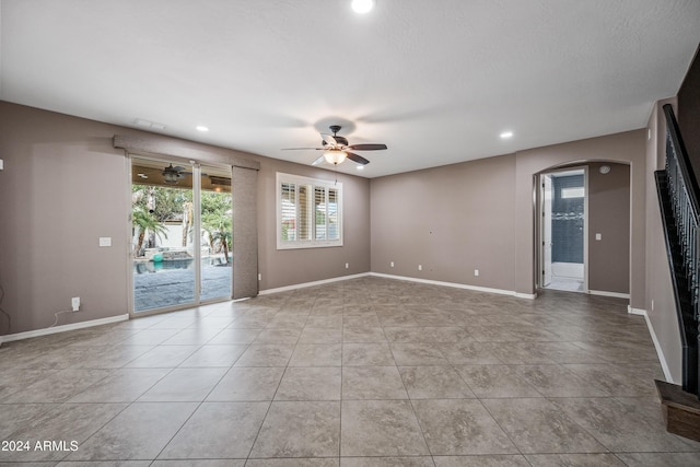 unfurnished room featuring ceiling fan and light tile patterned floors