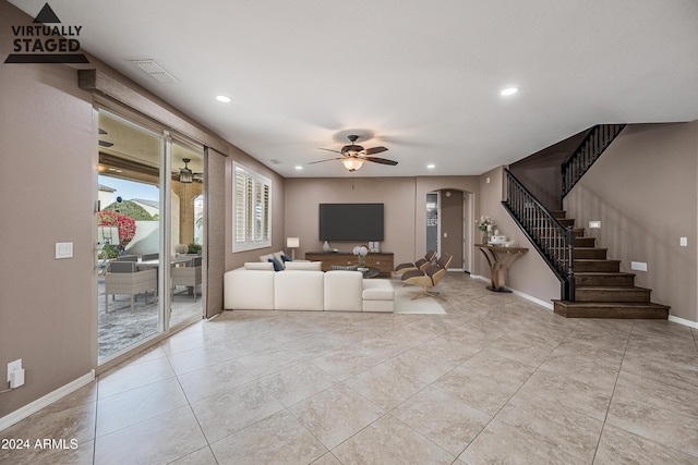 unfurnished living room with ceiling fan and light tile patterned flooring