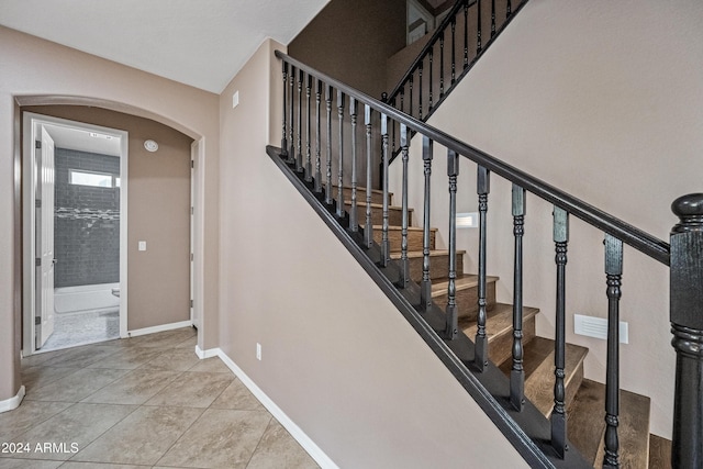 staircase with tile patterned floors