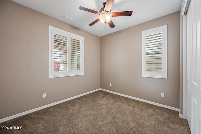 carpeted empty room featuring ceiling fan