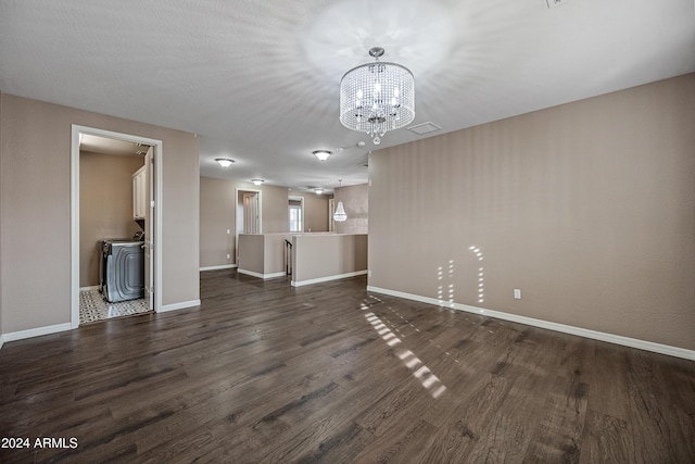 unfurnished living room with dark hardwood / wood-style flooring and a chandelier