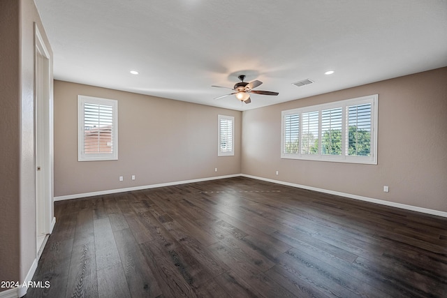 spare room featuring dark hardwood / wood-style floors and ceiling fan