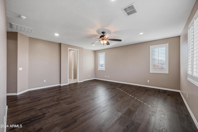 spare room with ceiling fan and dark wood-type flooring