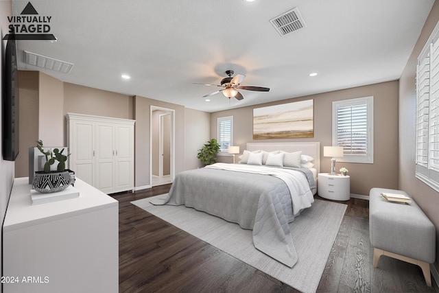 bedroom with multiple windows, ceiling fan, and dark wood-type flooring