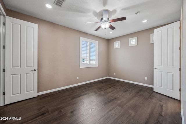 unfurnished bedroom featuring dark hardwood / wood-style floors and ceiling fan