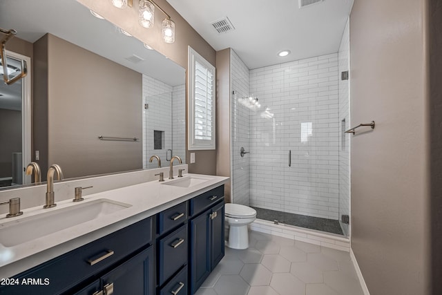 bathroom featuring tile patterned flooring, vanity, toilet, and walk in shower