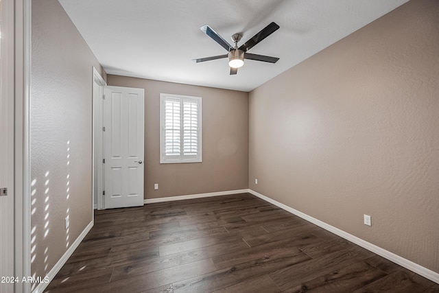 empty room featuring ceiling fan and dark wood-type flooring