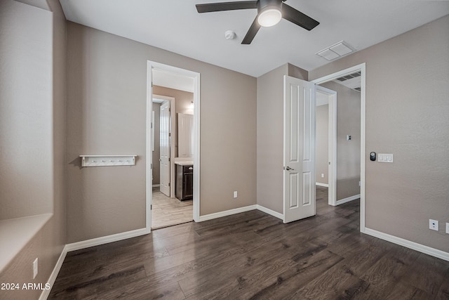 unfurnished bedroom with a closet, ceiling fan, and dark hardwood / wood-style flooring