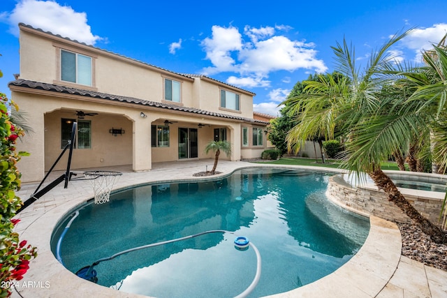 view of swimming pool with ceiling fan and a patio area