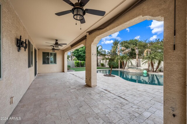 view of patio with ceiling fan and a fenced in pool