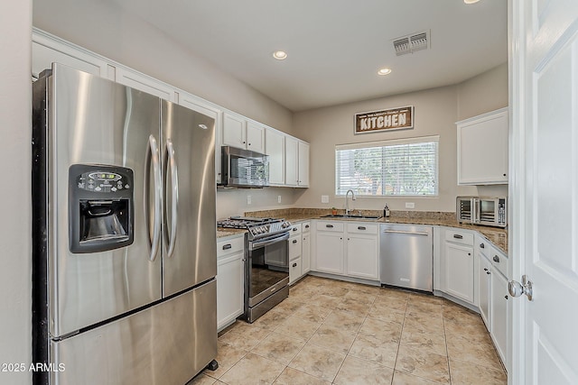 1482 S Banning St, Gilbert, AZ 85296 - kitchen with stainless steel appliances, a sink, white cabinetry, light stone counters, and recessed lighting
